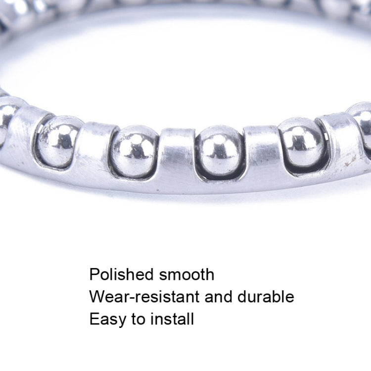 Close-up of polished metal roller bearing ring with ball bearings