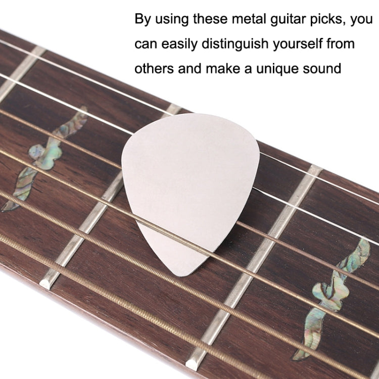 Metal guitar thumb pick with attached wire on guitar strings