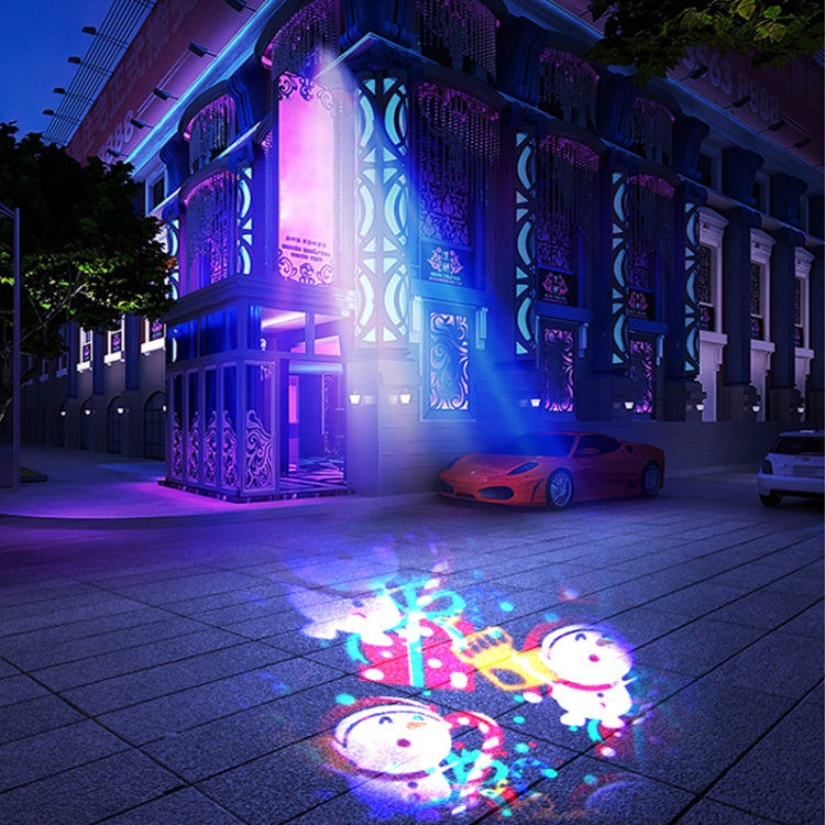 Colorful rotating Christmas laser light projection on pavement, blue and purple glow