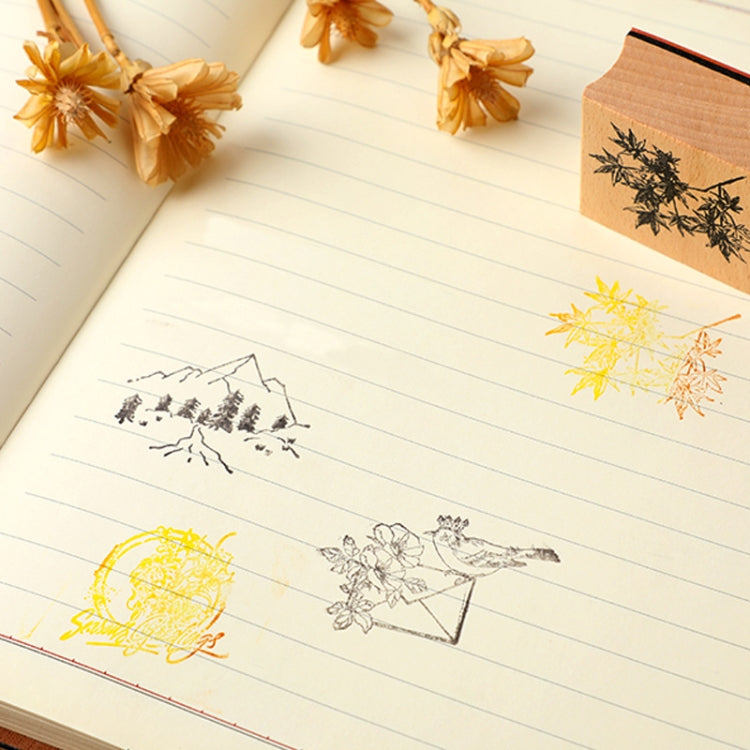 Notebook pages with yellow and black stamped designs using wooden landscape stamps
