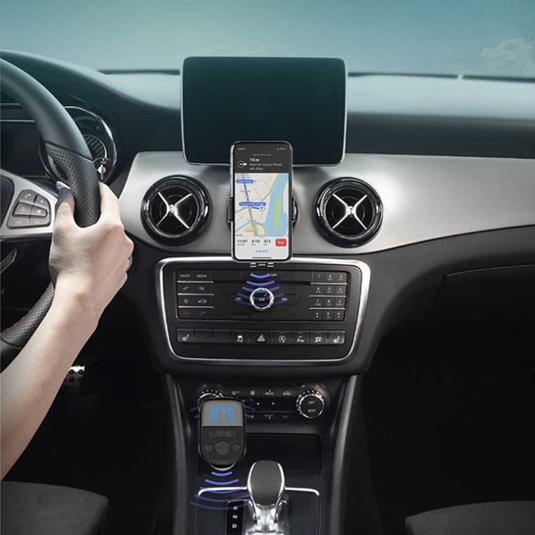 Car dashboard setup featuring a mounted Bluetooth FM charger and phone screen