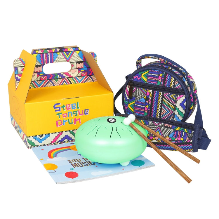 Green tongue drum with two wooden mallets, in open retail box