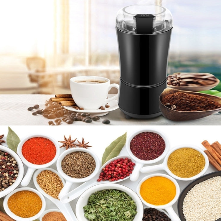 Black electric mini coffee grinder with clear lid beside bowls of ground coffee spices