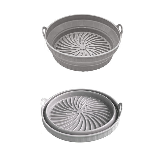 Gray round silicone air fryer grill mat with raised spiral grill pattern and side handles.