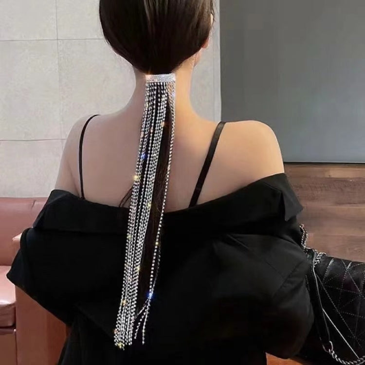 Rhinestone chain fringe hair band on back hair with long draping strands.