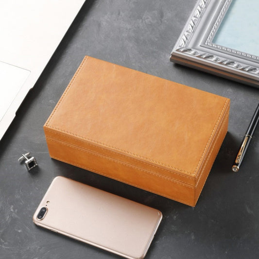 Brown stitched phone shielding box with hinged top flap and space for a phone