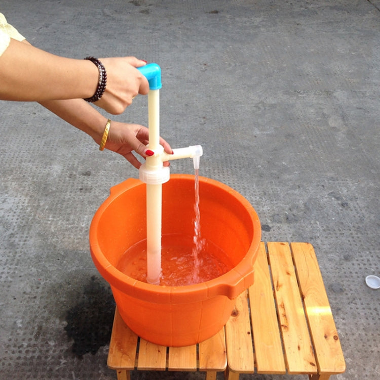 Manual oil extractor pump dispensing clear liquid into a bucket