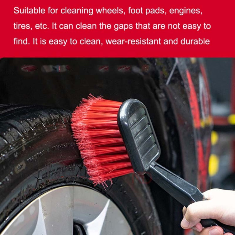 Car tire brush with red bristles scrubbing tire tread and sidewall