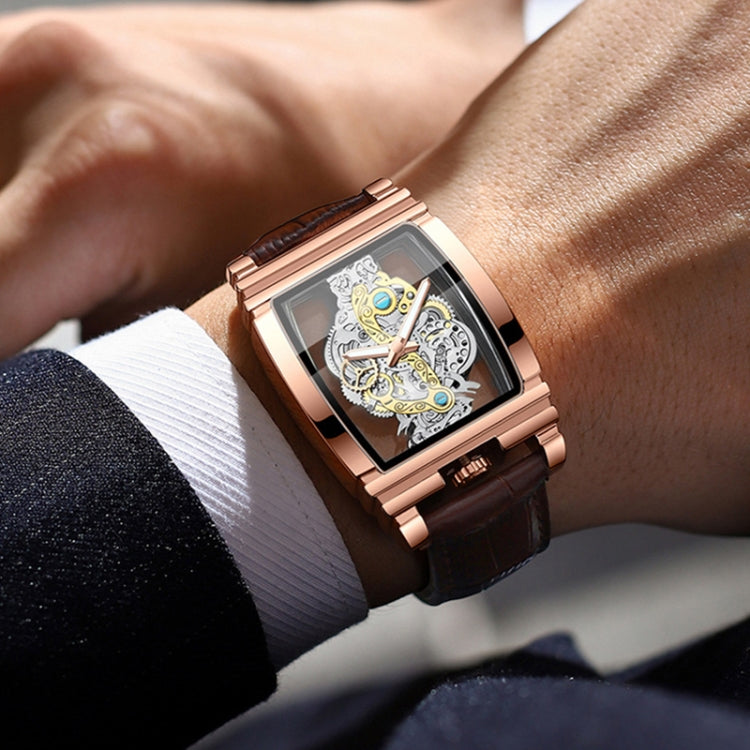 Men's rose-gold skeleton watch on wrist with brown leather strap and luminous dial