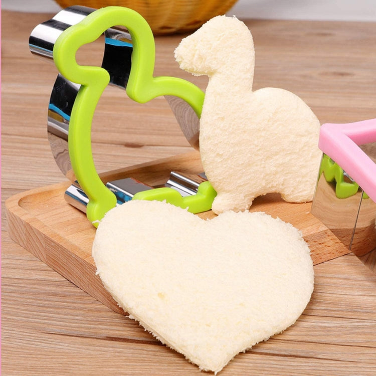Stainless steel sandwich bread cutter with green guard pressing bread into heart shape