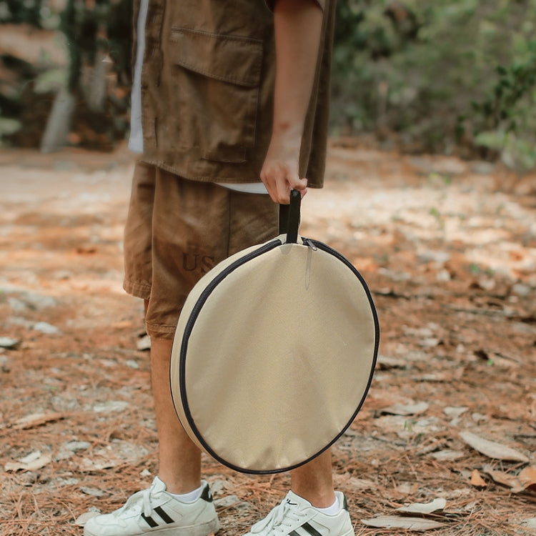 Folded round camping table carried with a fabric storage bag