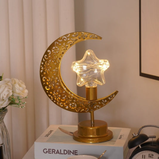 Gold moon-shaped LED table lamp with star cutout and glowing bulbs on base