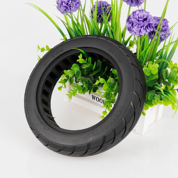Black solid scooter tire with diagonal tread and vented inner edge