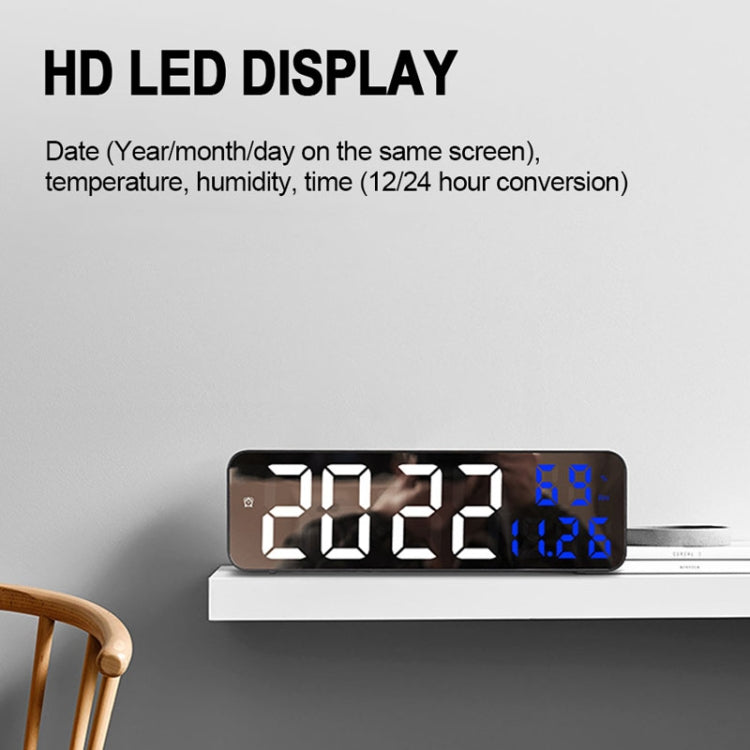 Mirror screen LED alarm clock with white date/time digits and blue temperature/humidity readout, black case.