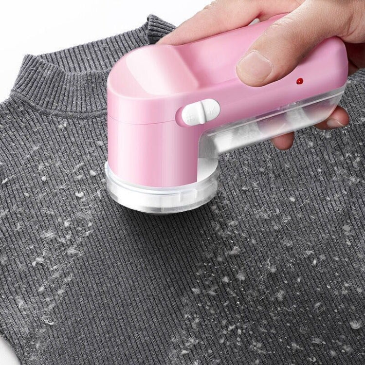 Pink garment lint remover shaving sweater fabric with round mesh head