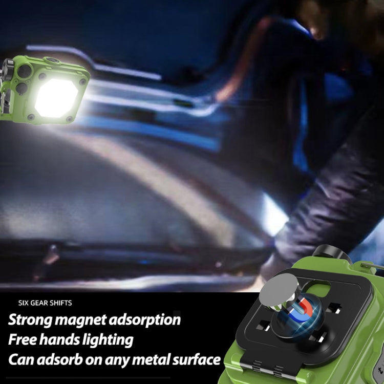 Green mini keychain LED flashlight with strong magnet base, seen in low-light