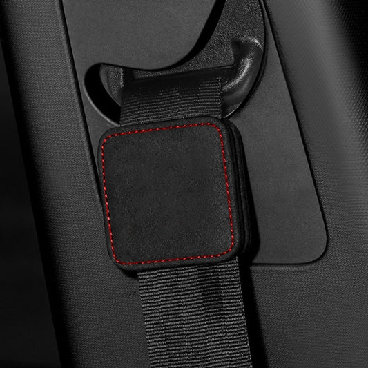 Black seat belt limiter pad with red stitched edge on car seat buckle strap