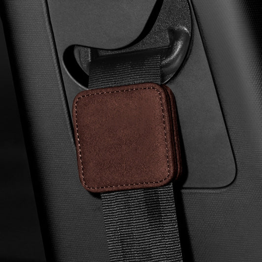Brown seat belt limiter pad with contrast stitching on car seat belt webbing