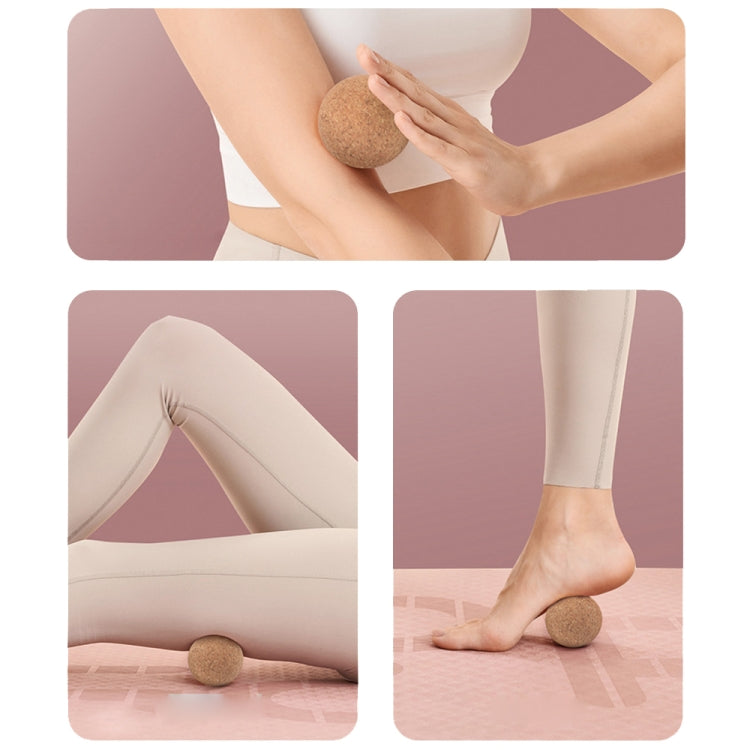 Cork massage ball used for leg stretching and muscle recovery.