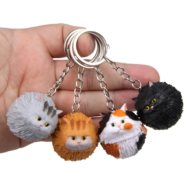 Cartoon cat keychain with metal key ring, silver chain, four round cat faces in black, white, orange