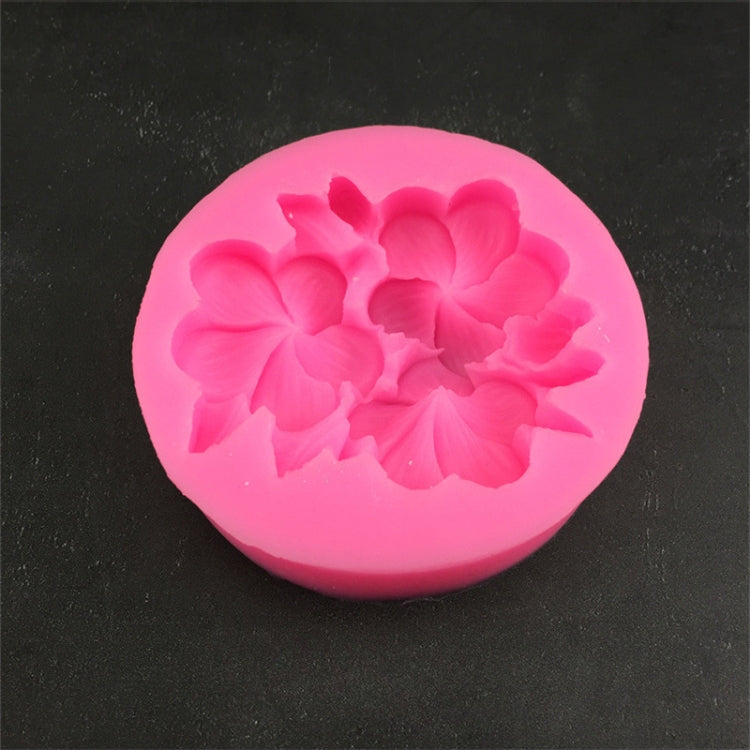 Pink silicone 3-petal flower mold close-up with raised gardenia-style blossom
