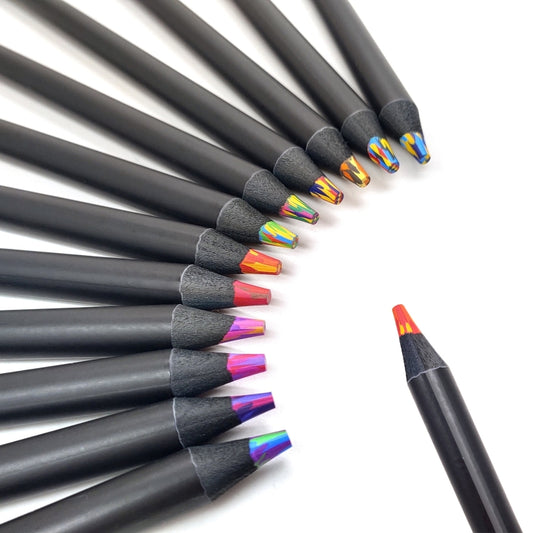 Black wooden rainbow pencils arranged in a line, showing colorful patterned tips