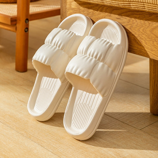 White EVA couple slippers, slip-on design with ribbed strap and textured footbed, pair