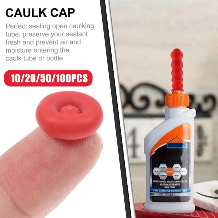 Red caulk nozzle sealing cap sleeve shown in hand next to glue bottle