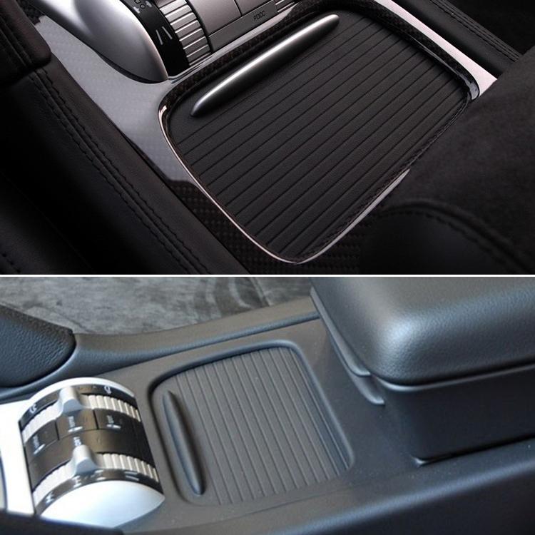 Installed black ribbed cup holder cover trim with oval opening in car console