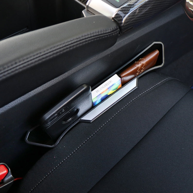 Black car seat gap storage tray with clip, holding wallet and phone