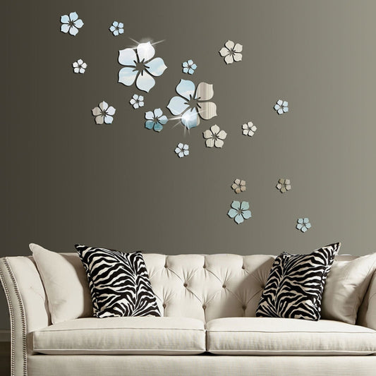 Silver cherry blossom mirror wall stickers with scattered flower shapes above a sofa.