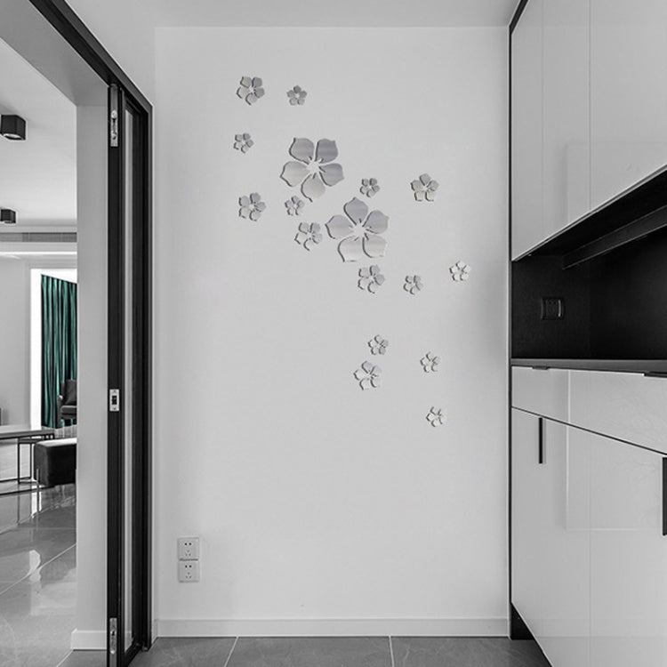 Silver cherry blossom mirror wall stickers arranged on a hallway wall near a corner.