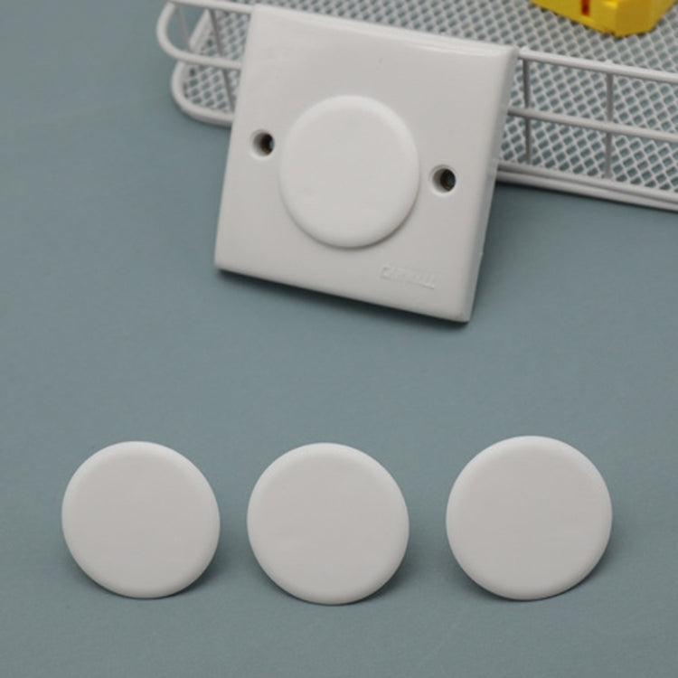 White UK wall outlet with round white socket protection covers and plugged cover