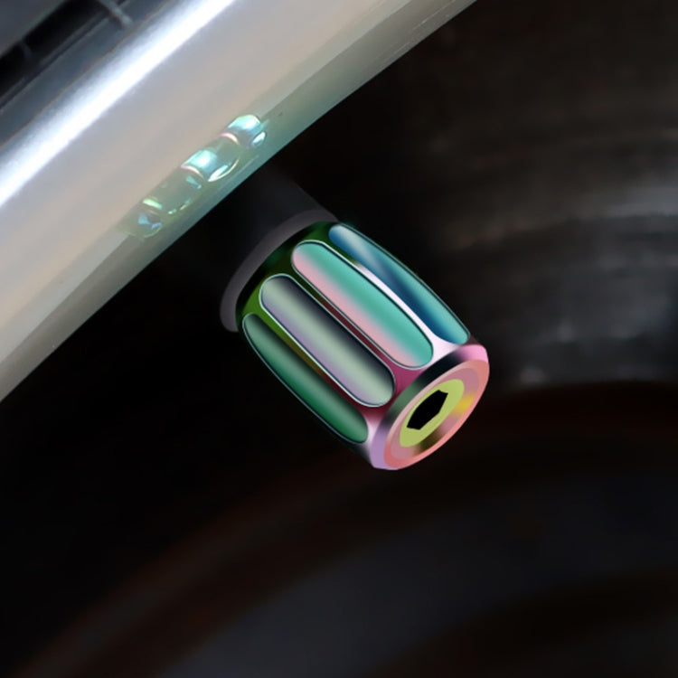 Colorful metal anti-theft tire valve cap on valve stem with iridescent finish