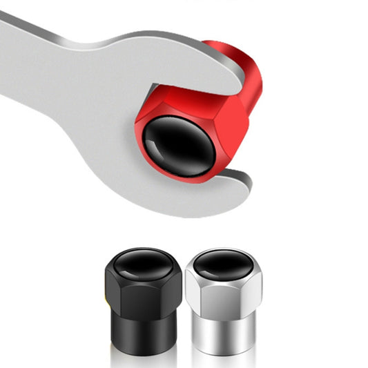 Hexagonal tire valve caps pair in black and silver with black rubber valve openings