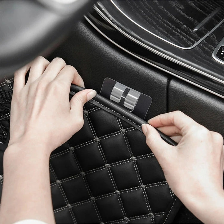 Clear adhesive buckle sticker applied to stitched car mat surface