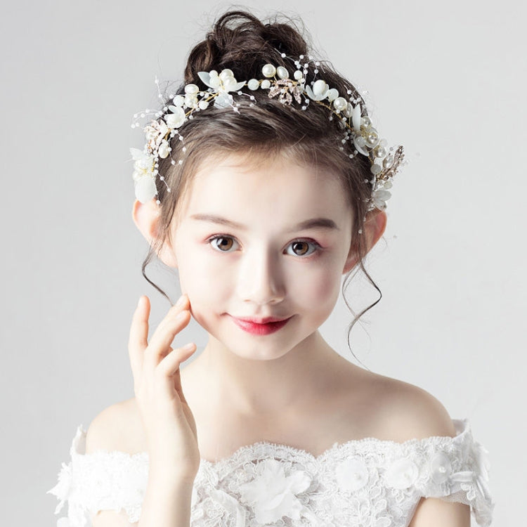 White pearl and flower wreath hair band on a model's hair, off-shoulder dress