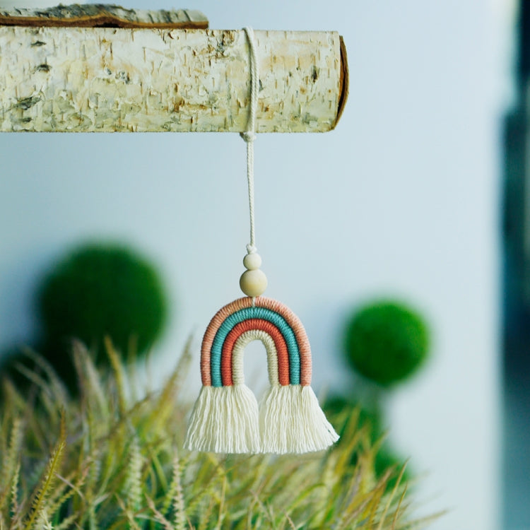 Rainbow wood bead tassel pendant hanging by cotton rope from a wooden dowel