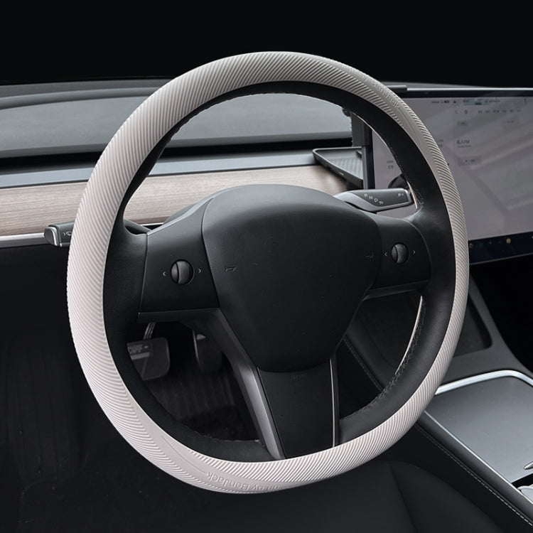 Beige ribbed silicone steering wheel cover installed on a car steering wheel.