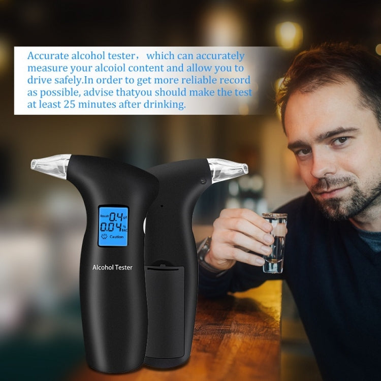 Black breath alcohol tester with LCD display and clear mouthpiece near a drink