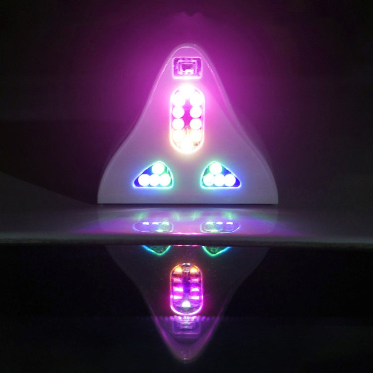 Glowing solar shark-fin warning antenna with multicolor LEDs in triangular layout