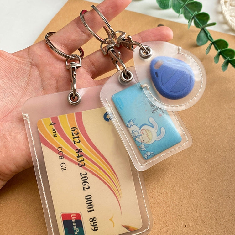 Clear card protector keychain with water-drop fob, blue core showing cartoon card