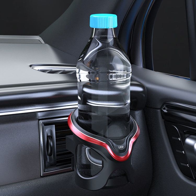 Black car air vent cup holder with red LED ring, holding a bottle near the outlet