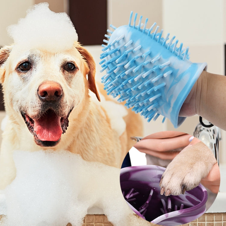 Blue silicone dog paw cleaning brush grooming a dog with foam
