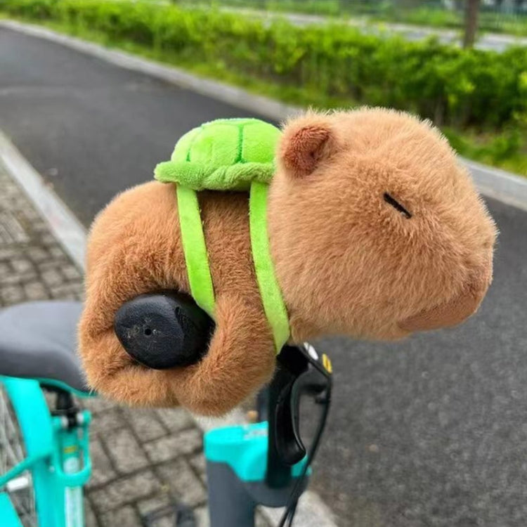 Brown plush animal snap ring bicycle accessory with green strap and black wheel attachment