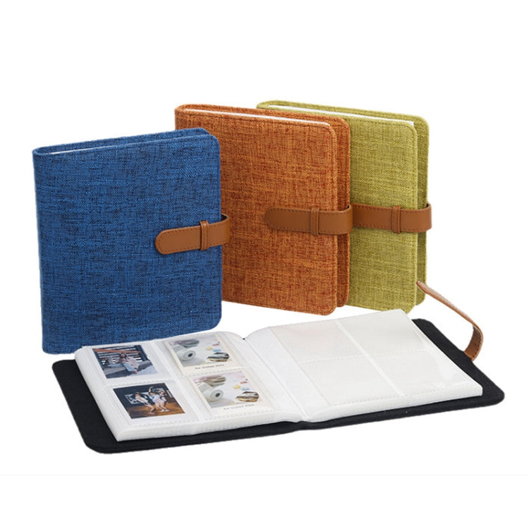 Cotton linen photo album with orange, blue, and green covers; open pages displayed