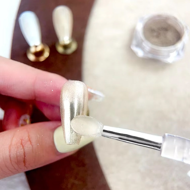 Silicone applicator stick dabbing powder onto a fingernail with glitter effect