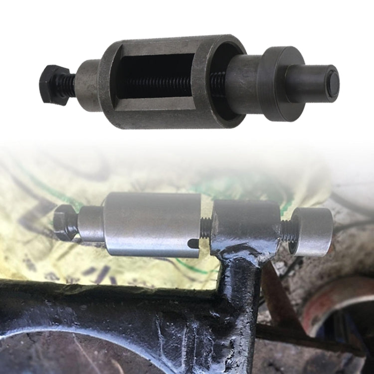 Shaft cushion sleeve removal tool in use on scooter axle; dark metal threaded parts