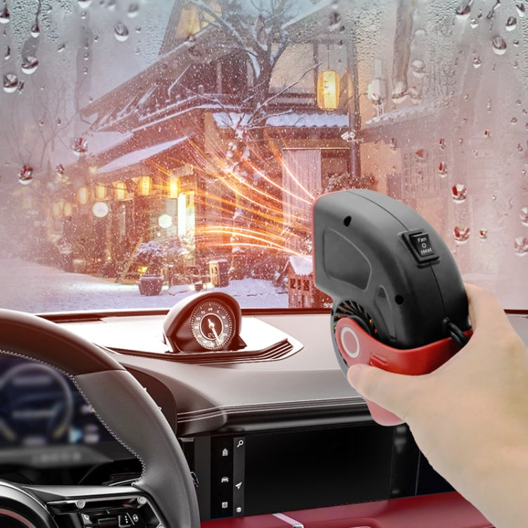Portable car heater and defogger with black body and red accents, hand holding on dashboard