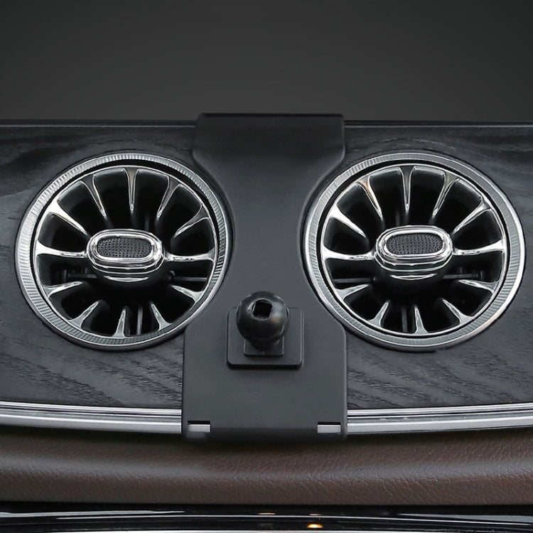 Black phone holder base clipped to car air vent, left-hand drive